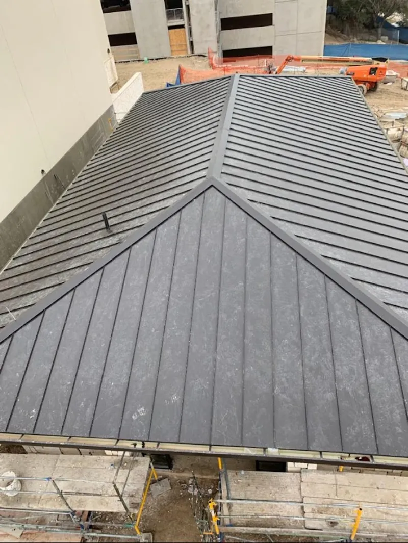 Commercial metal roof construction with crane equipment in Upper Hanover